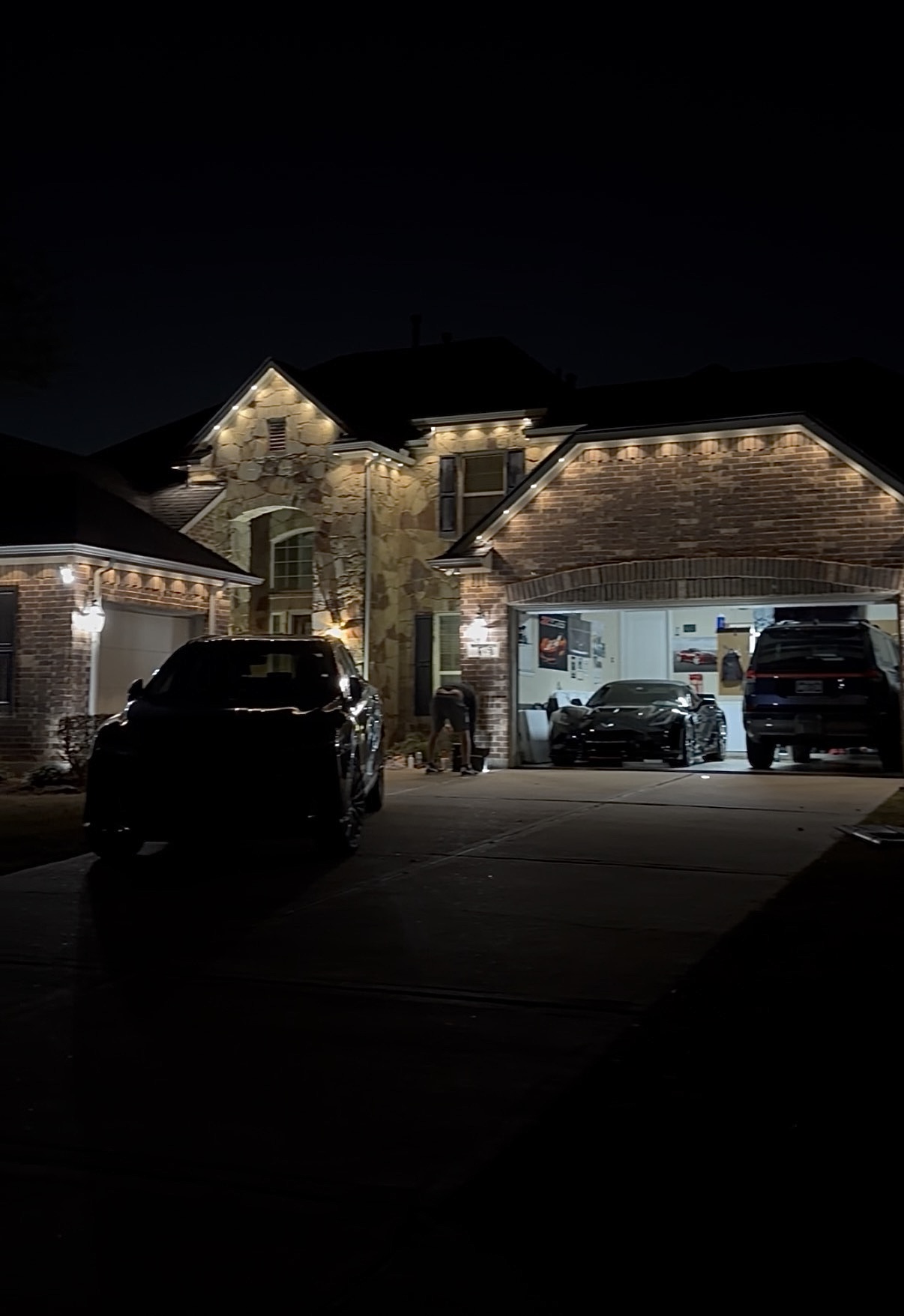 Warm white permanent LED trim lighting on a brick home in Spring TX