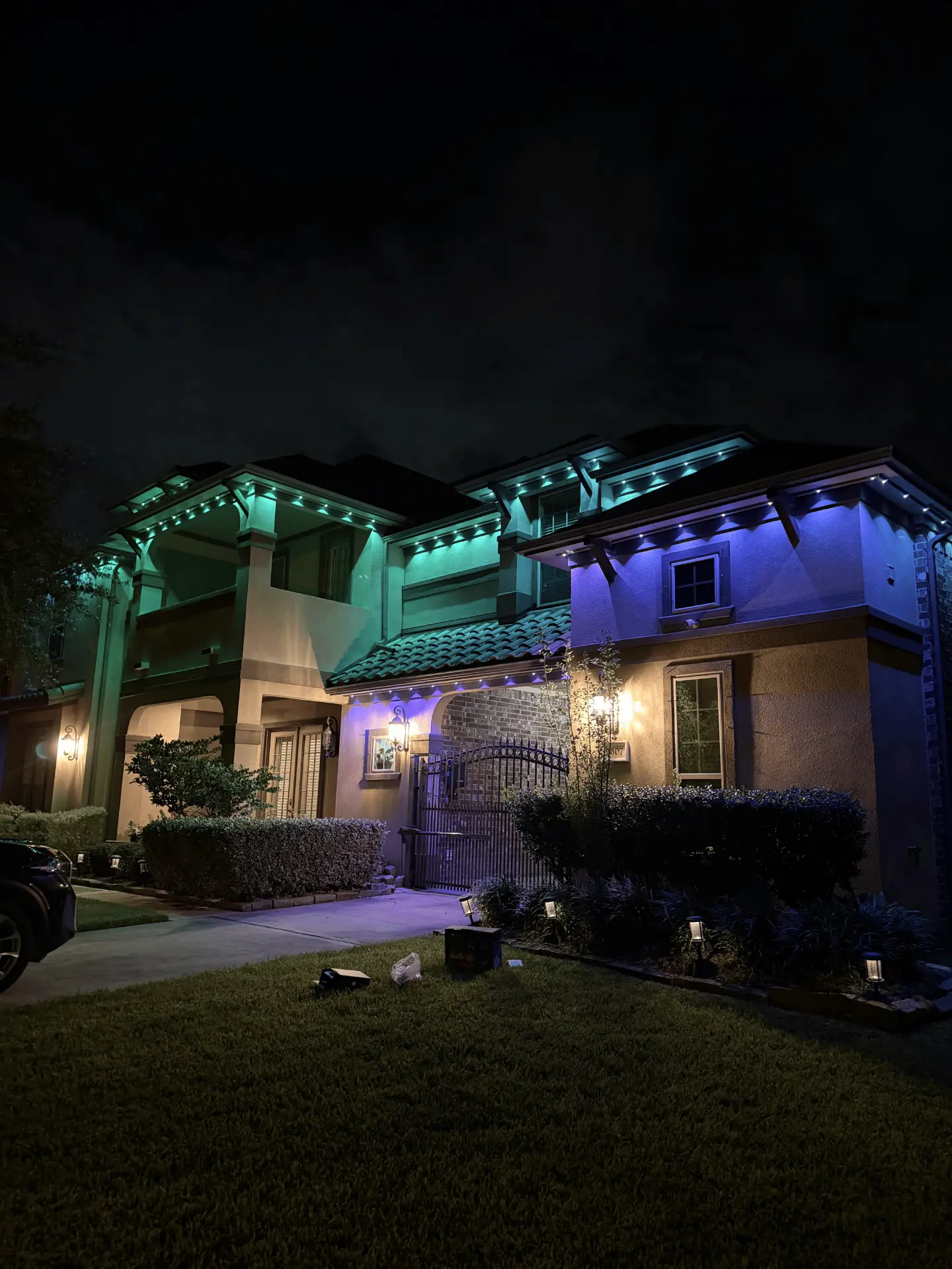 Teal and purple permanent LED lighting on a Sugar Land home