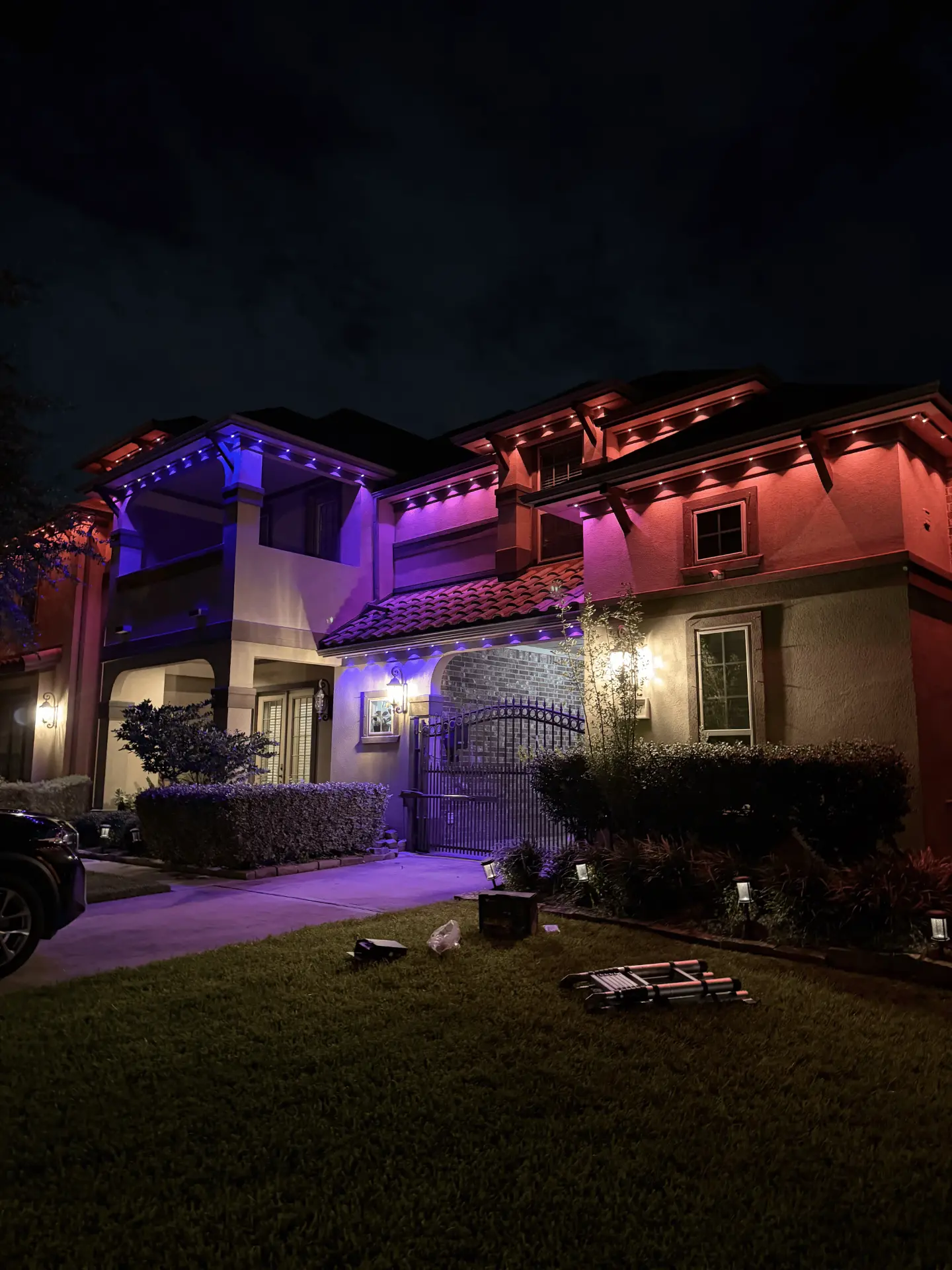 Purple and red permanent LED accent lighting on a Cypress home